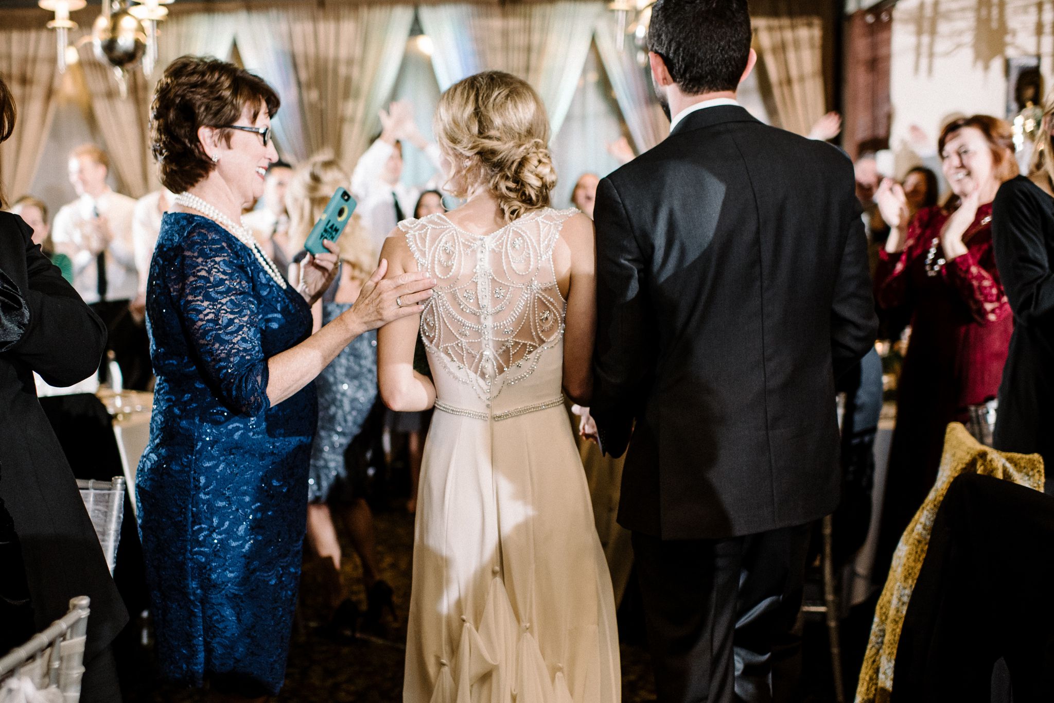 A bride and groom enter their reception at The Larimore House