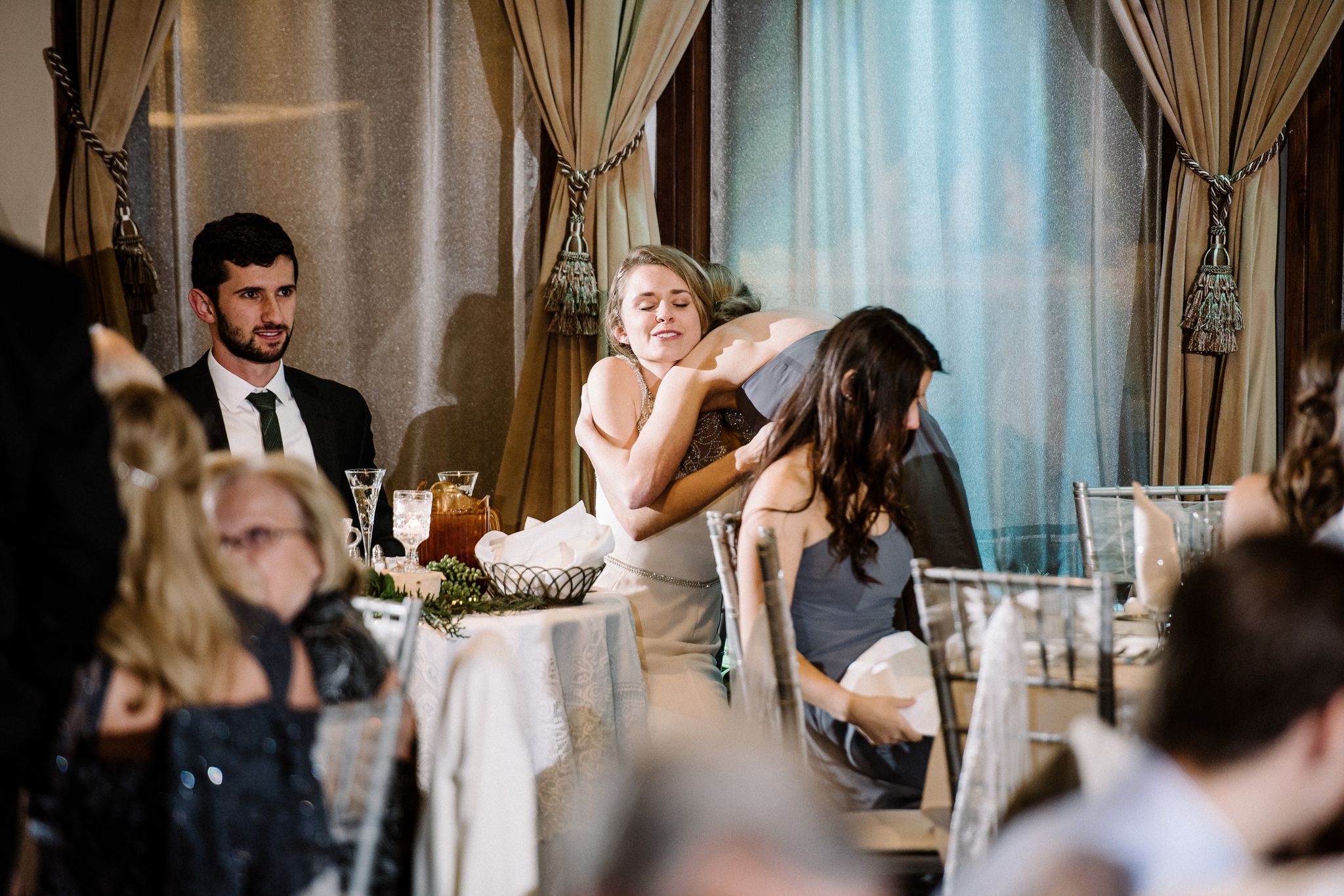 the bride hugs her sister after the maid of honor toast