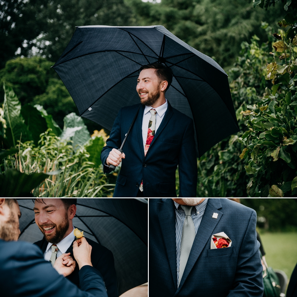 A groom holds an umbrella during his Rainy Day Wedding Photos in St Louis